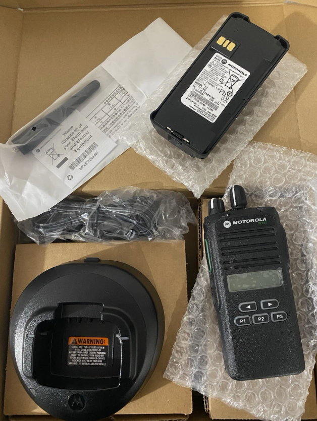 Motorola CP185 analog radio voice scrambling activation button and X-Pand audio processing menu detail on display