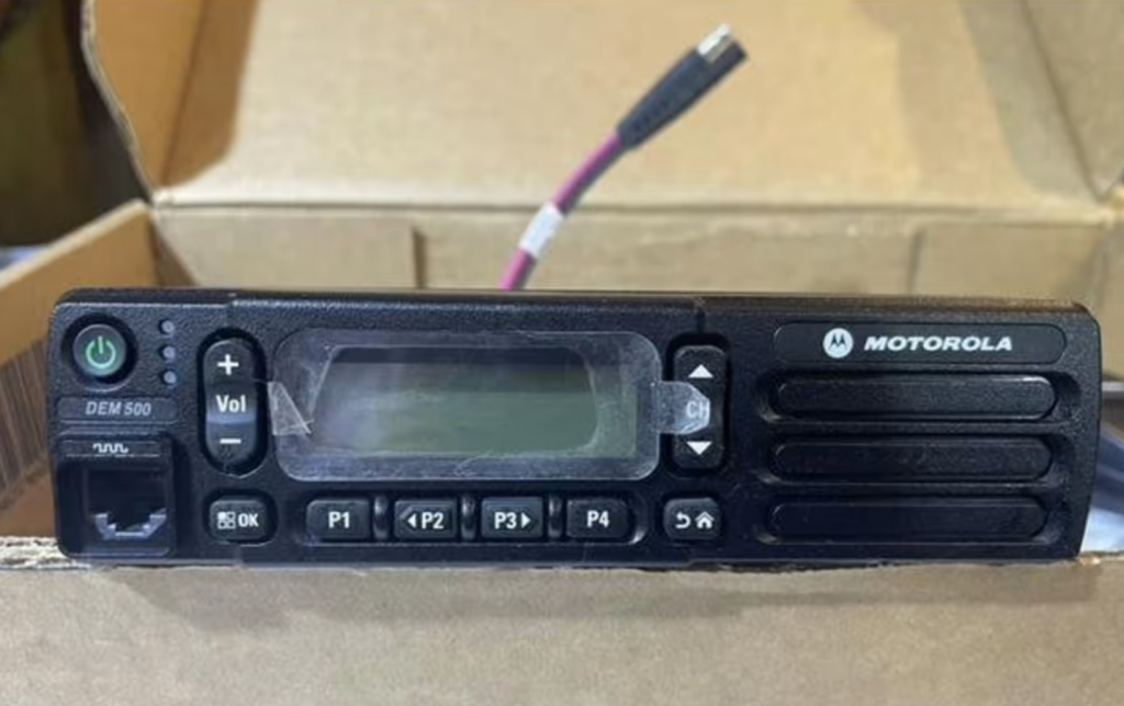 Motorola DEM500 mobile radio back panel showing mounting bracket, antenna connector, IP54 sealing and MIL-STD rugged construction