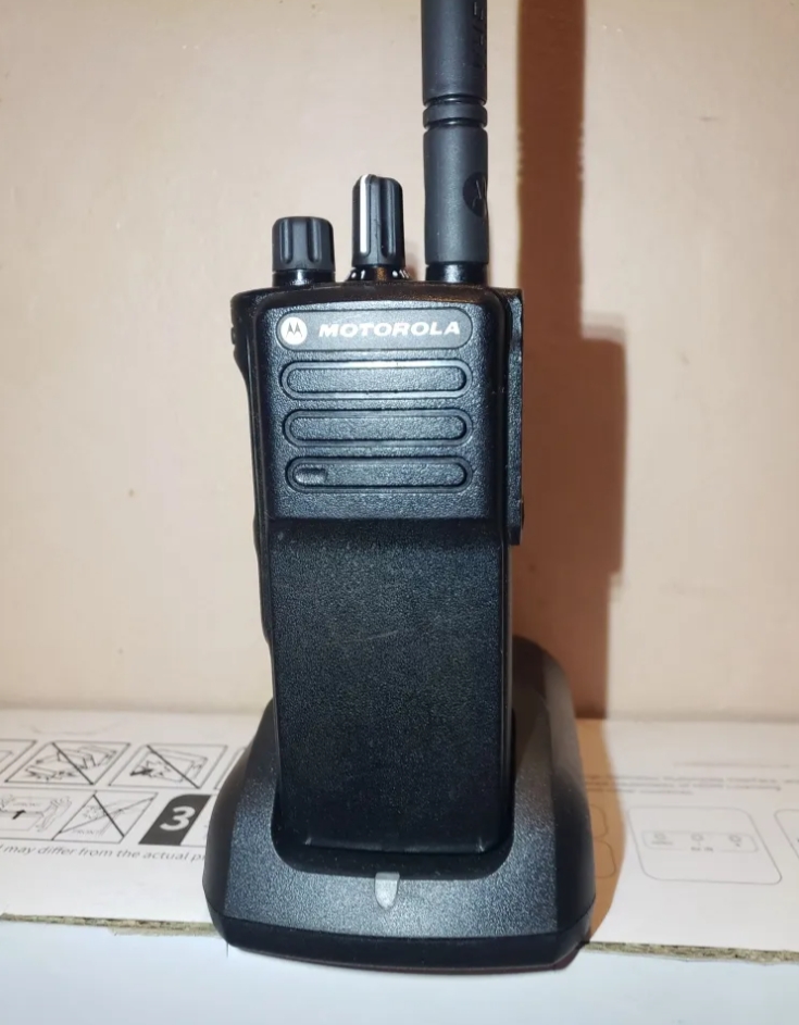 Motorola DGP5050E radio back and side view showing rugged military standard housing, belt clip, battery release and VHF UHF band marking