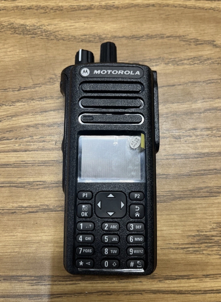Motorola DGP5550 radio side and back view showing full keypad layout, battery release, belt clip and VHF UHF band marking