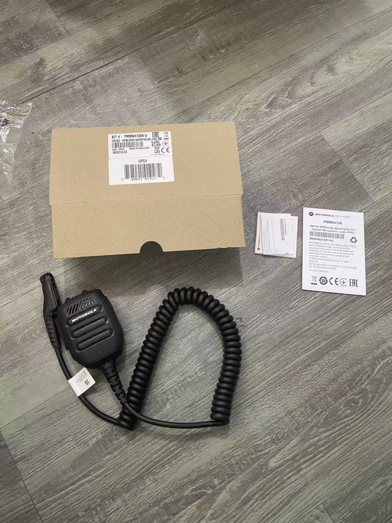 Motorola PMMN4128 RM780 speaker mic showing IMPRES Windporting port, 3.5mm audio jack, volume controls and IP68 sealed body